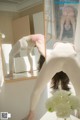 A woman doing a handstand in front of a mirror.